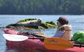 A young kayaker and a seal have a close encounter